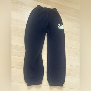 Black free city sweatpants with cream logo.